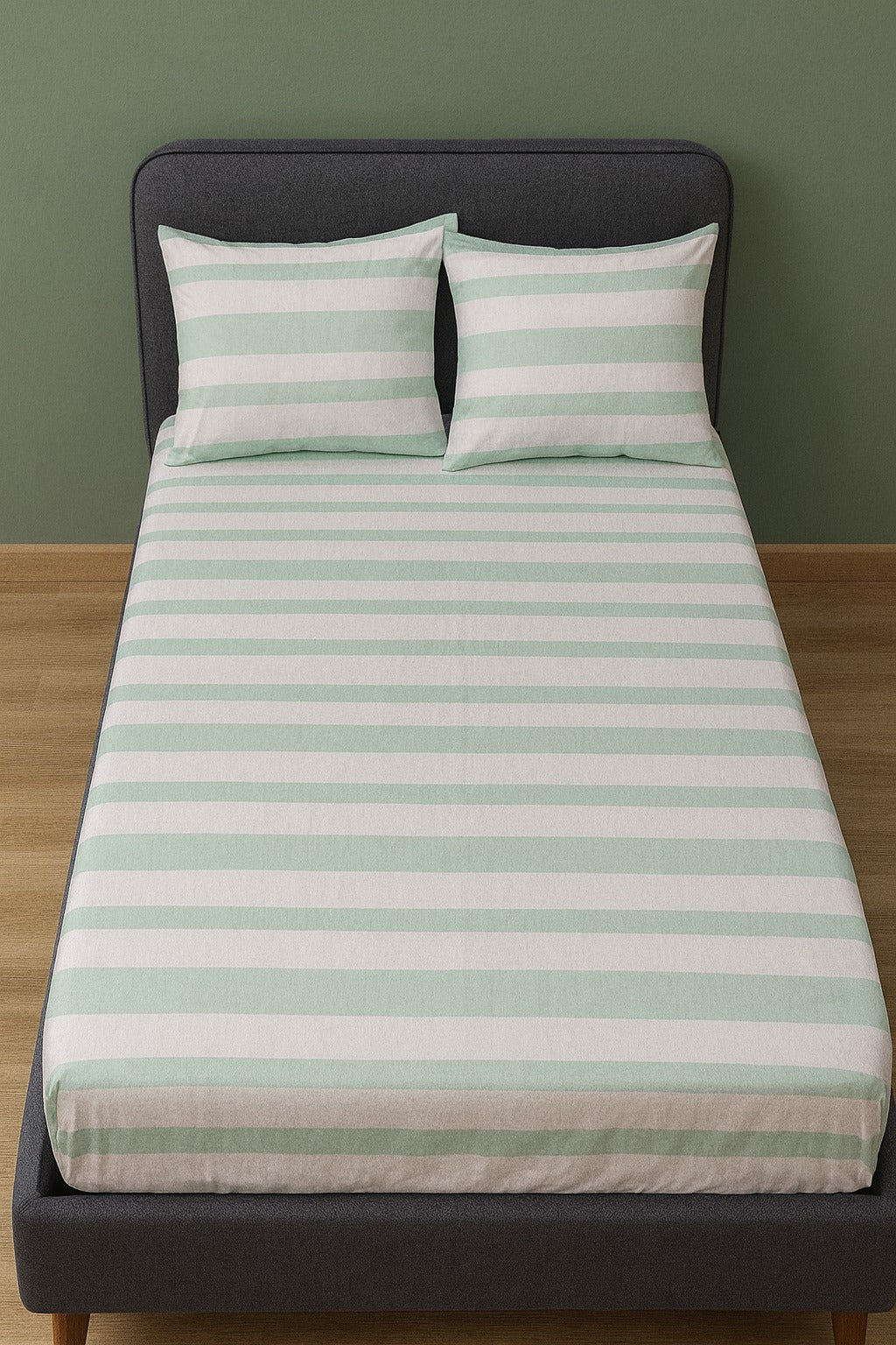 Sriped tbed sheet set on a bed with a green background