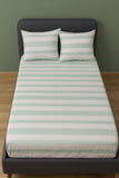 Sriped tbed sheet set on a bed with a green background