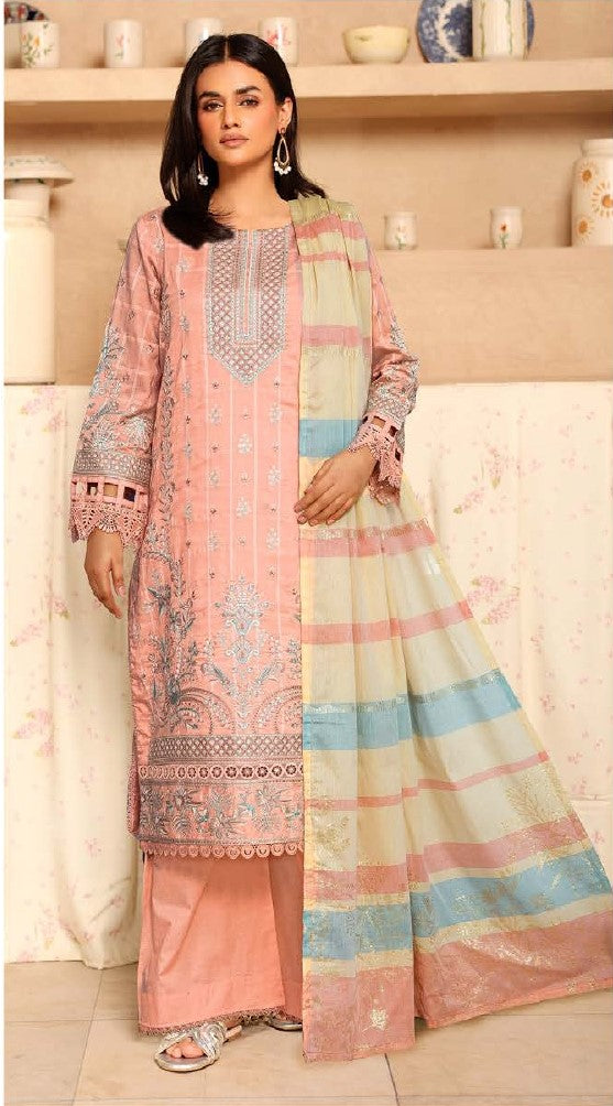 Woman wearing a traditional outfit with a pink and multicolored dupatta in a decorated room.