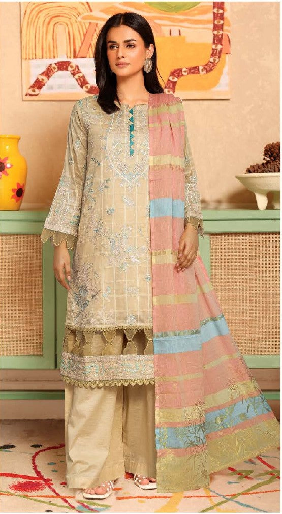 Woman wearing a traditional outfit with a colorful dupatta in a decorated room.