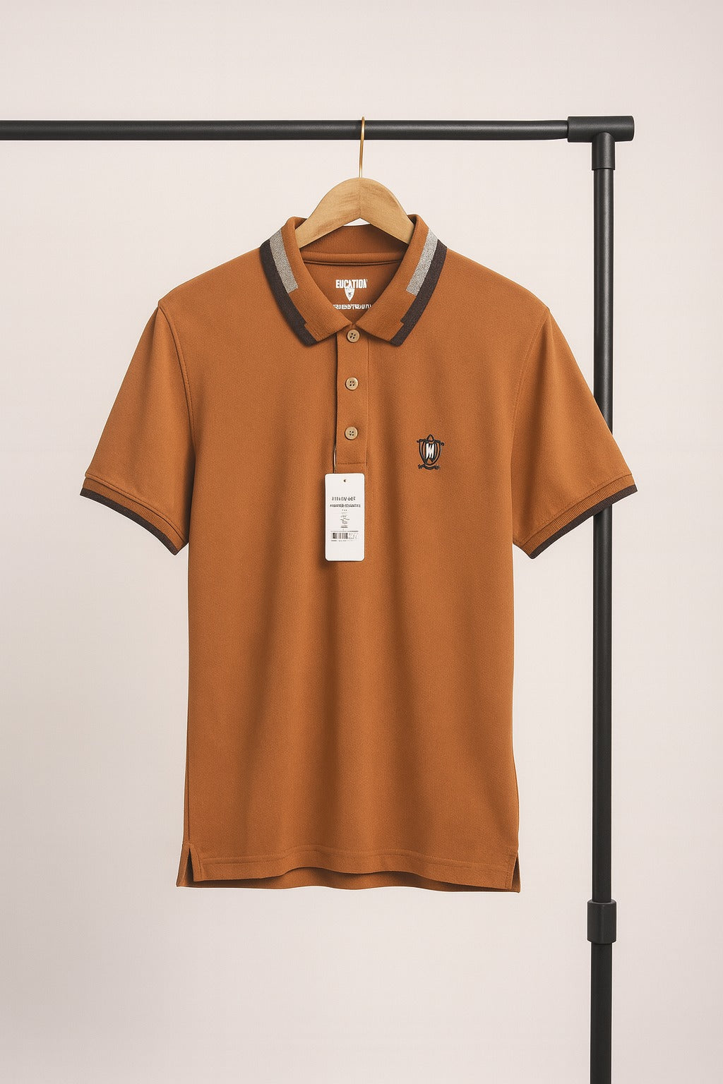 mastard polo shirt on a hanger against a plain background