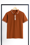 mustard polo shirt with 'CULTURE' text on a hanger against a white background