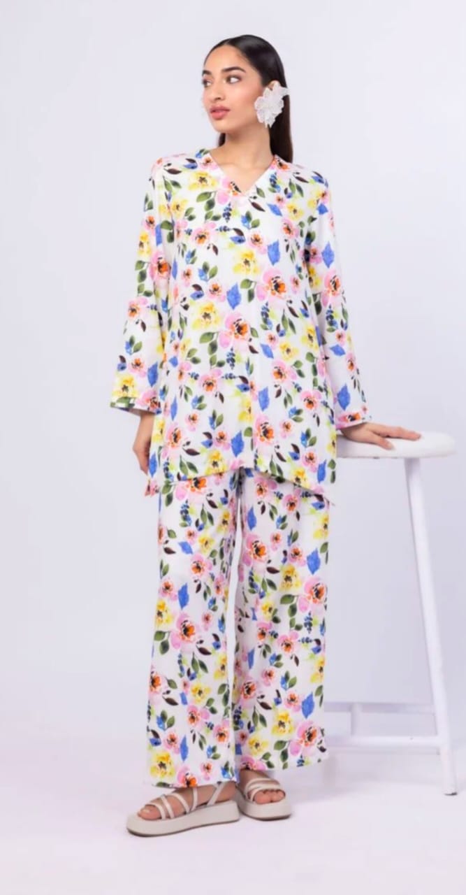 Woman wearing a colorful floral outfit on a white background