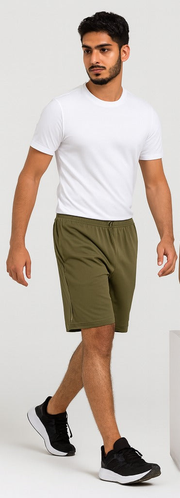 Man wearing a white t-shirt and olive         green shorts on a white background