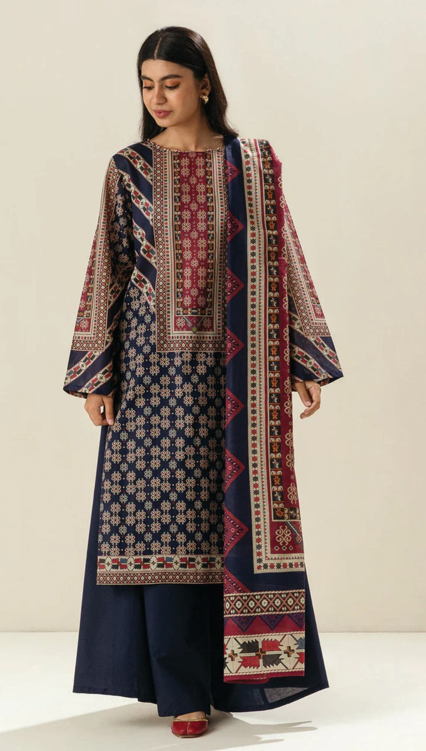 Woman wearing a traditional Printed outfit with a plain background