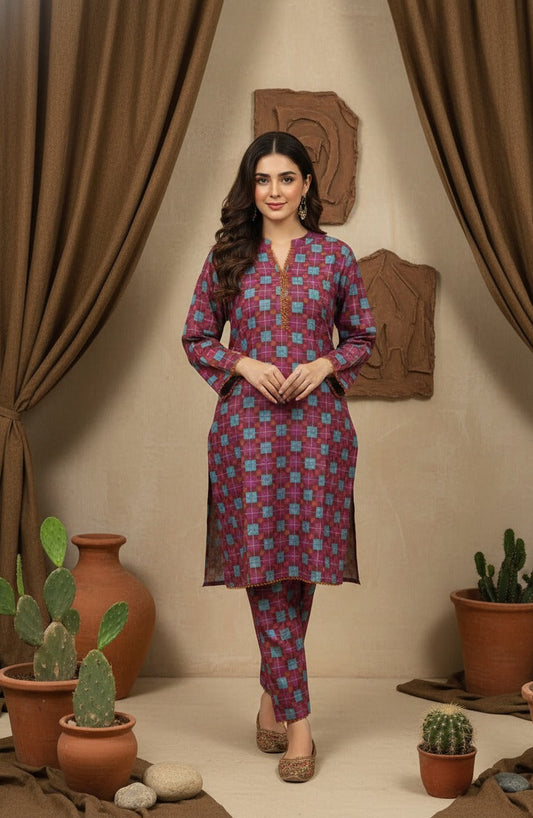 Woman wearing a patterned kurta with pants in a room with plants and decorative items.