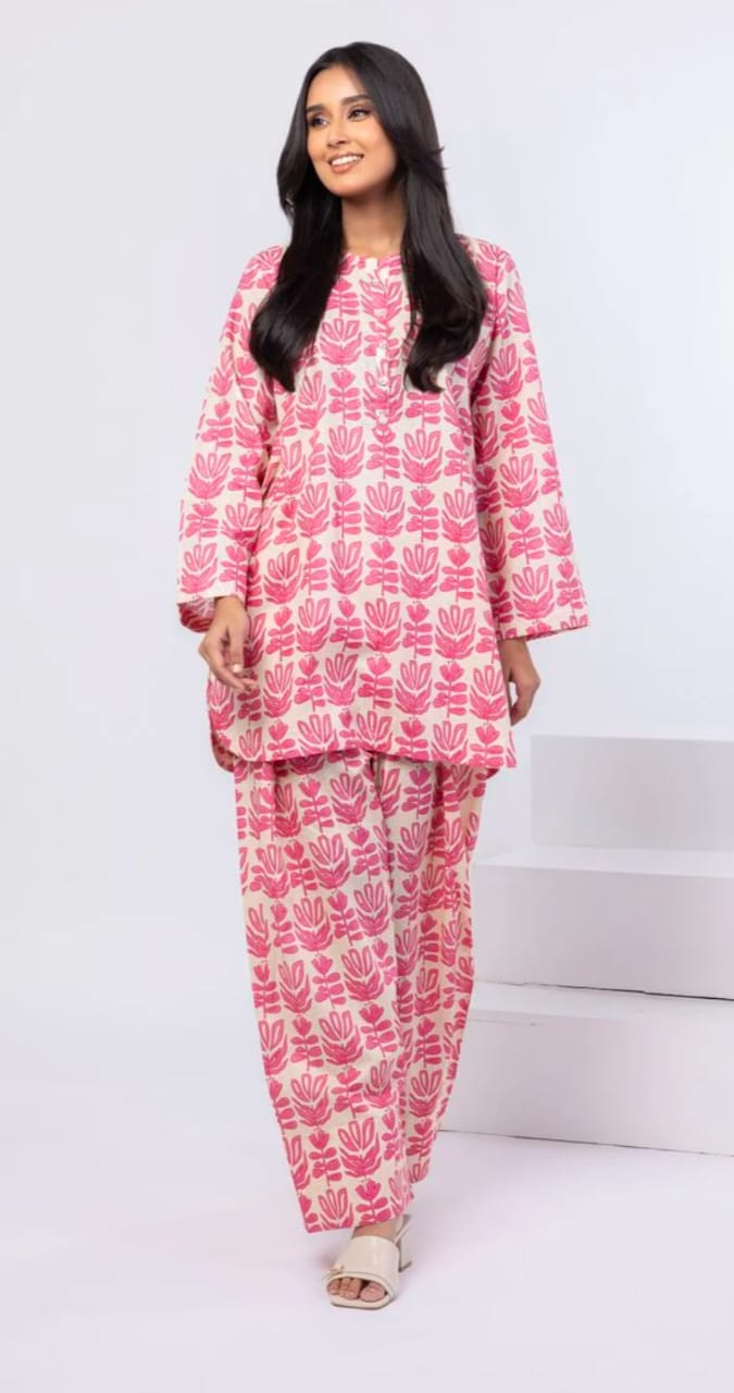 Woman wearing a pink and white patterned outfit on a white background