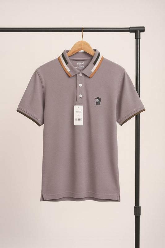 purple polo shirt with a brand logo on a hanger against a beige background