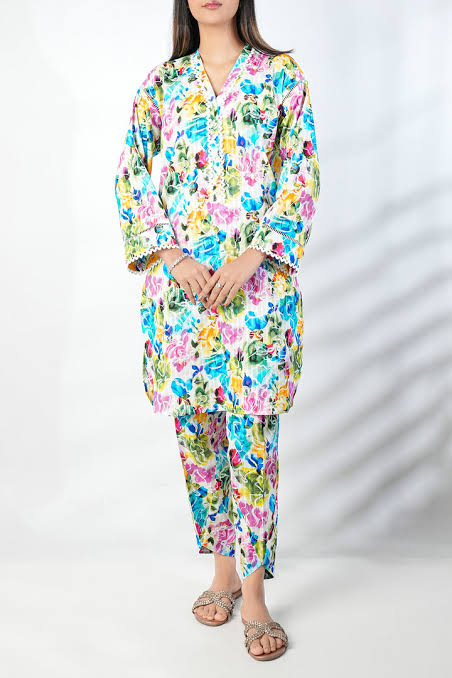 Woman wearing a colorful floral outfit on a white background